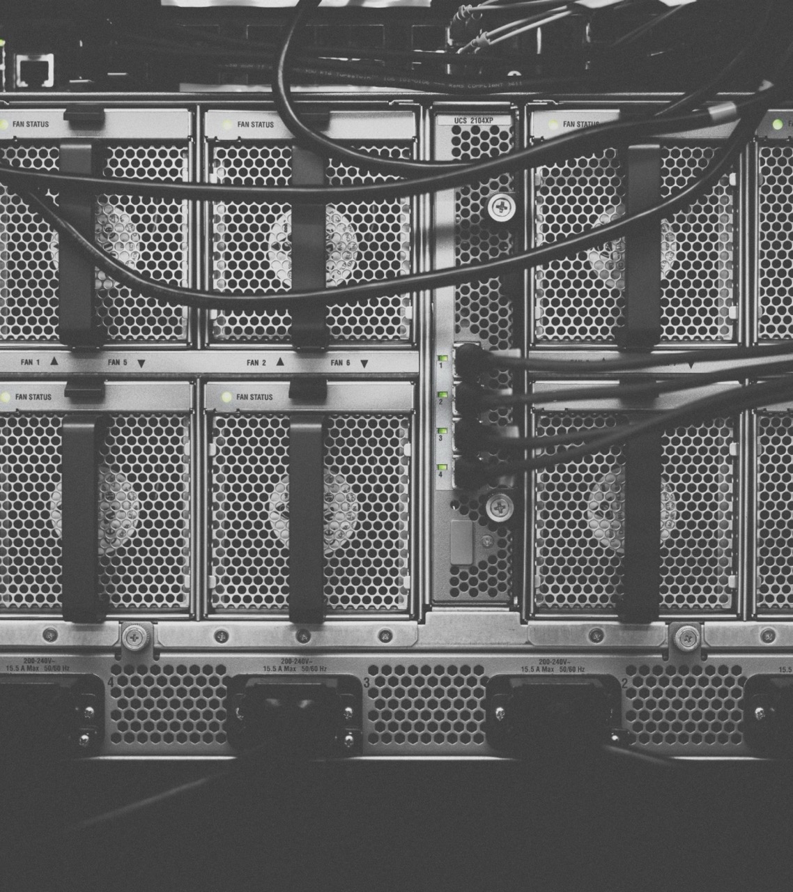 Close-up of server hardware showing perforated metal panels and cable management in black and white